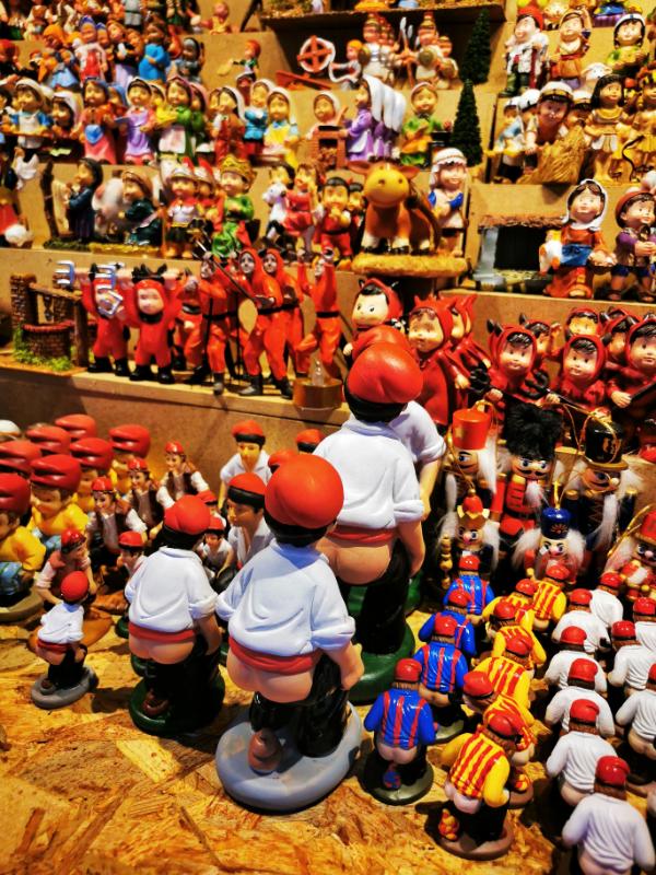 Caganers on a stall at La Feria de Santa Llucia - Christmas Souvenirs from Barcelona