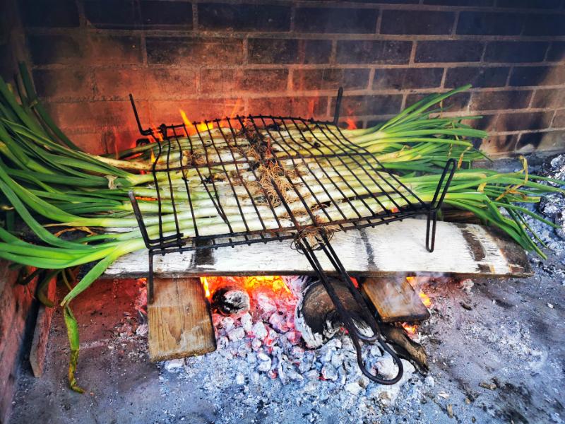 Calcots Grilling on a Barbecue - What to do in Barcelona in March