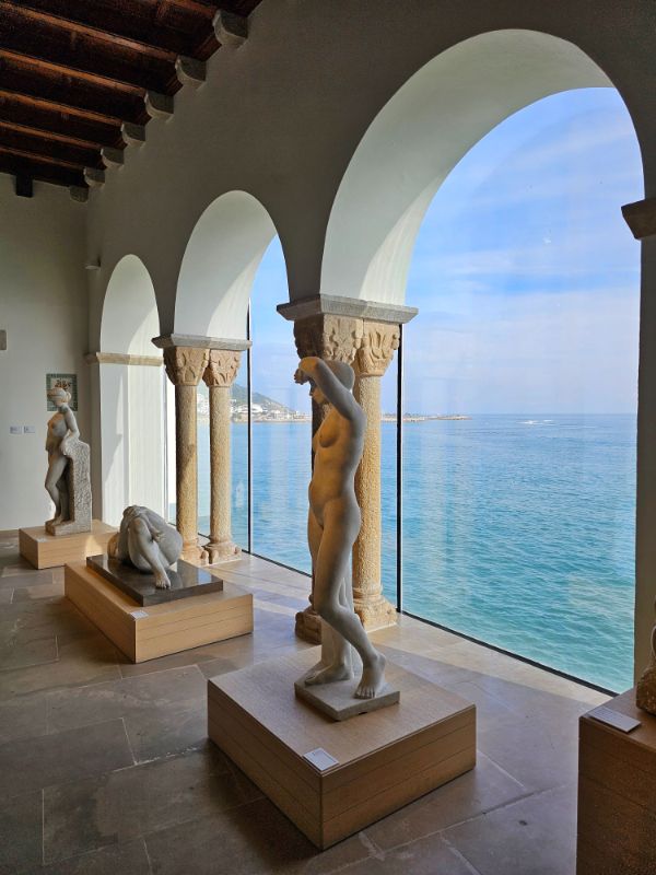 Inside the Museu de Maricel in Sitges with views of the sea through arched windows