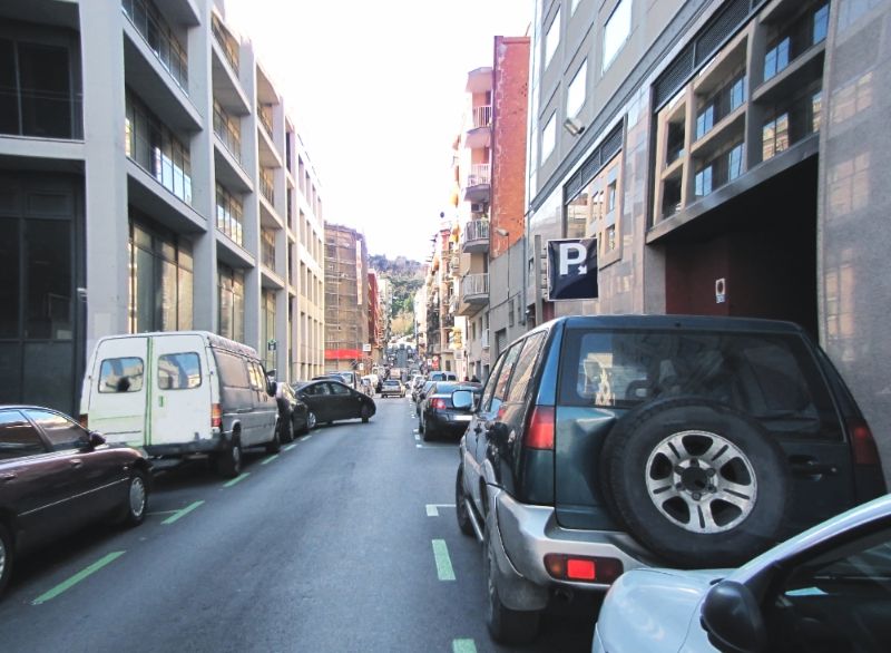 Narrow Road in Barcelona with Cars Parked on Both Sides