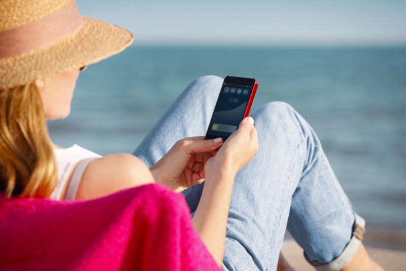 Woman with a Phone on the Beach in Barcelona