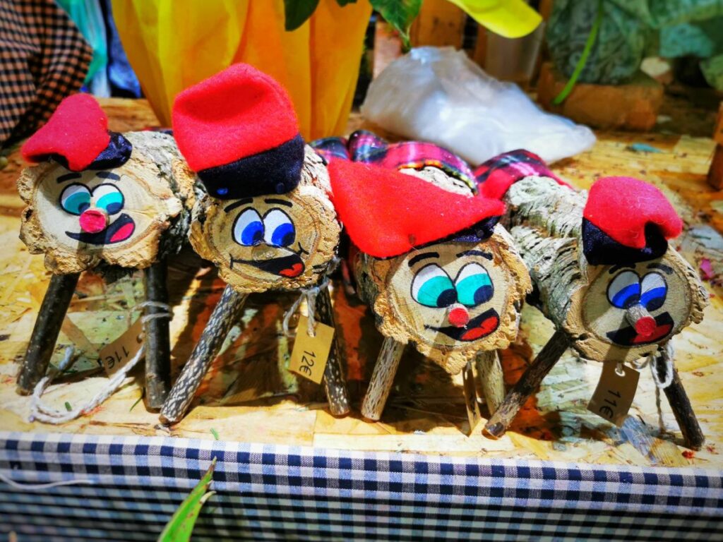 A Row of Caga Tios Pooping Christmas Logs - What to Do in Barcelona in December