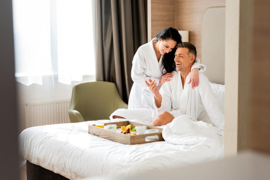 Couple in a Hotel Room enjoying Breakfast in Bed - Best Romantic Hotels in Barcelona