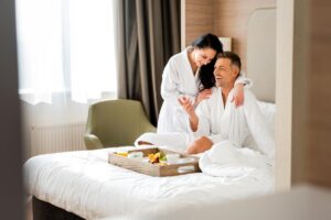 Couple in a Hotel Room enjoying Breakfast in Bed - Best Romantic Hotels in Barcelona