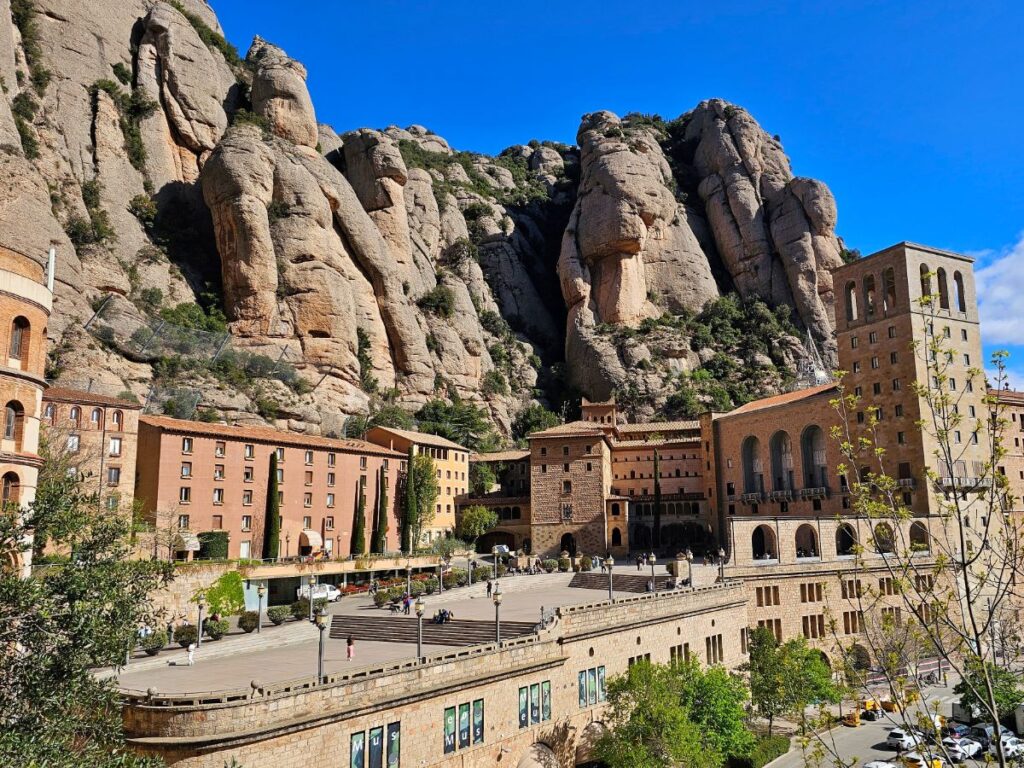 Montserrat Monastery with Serrated Mountain Peaks Behind - How to Get to Montserat from Barcelona