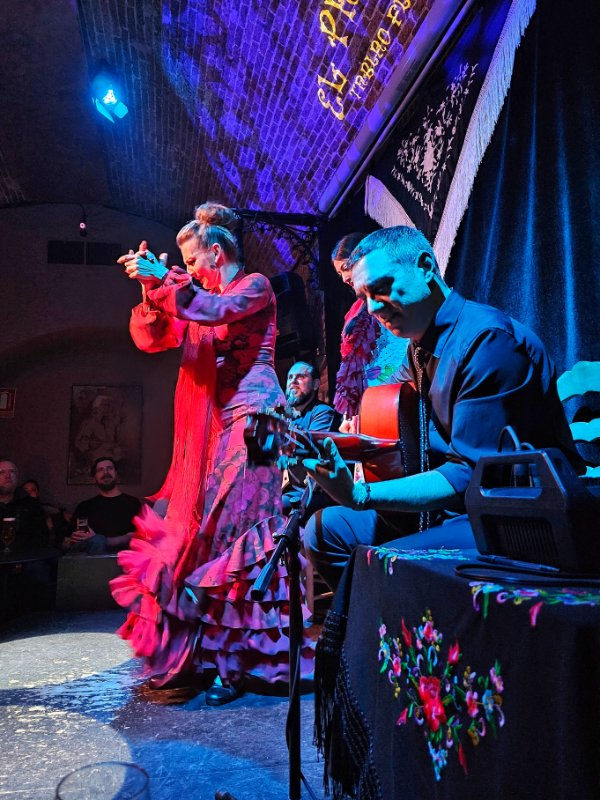 Flamenco in Barcelona - a woman dancing flamenco with a man playing guitar at a flamenco show in Barcelona