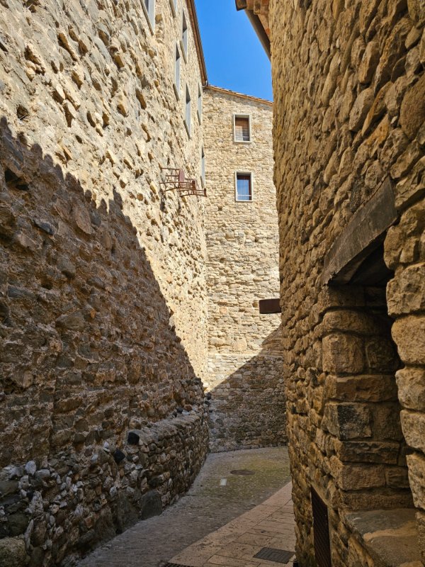 Artwork in Besalu - Chairs on the Side of a Medieval Building